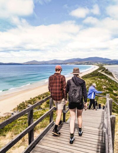 A man and woman walking down the stairs at the Truganini Lookout at The Neck on Bruny Island, Tasmania