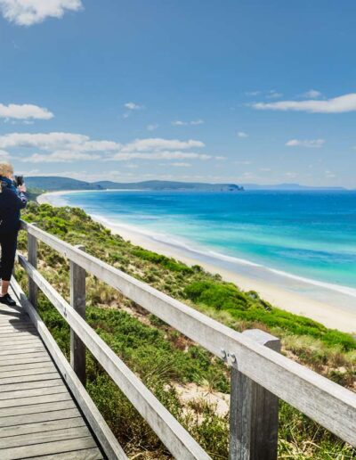 Lady taking photo with phone camera at The Neck Lookout, Bruny Island, Tasmania