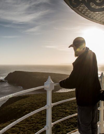 Man looking out to sea from the balcony of Cape Bruny Lighthouse